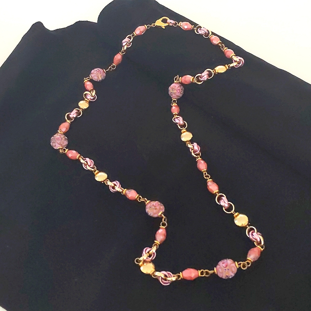 A 3 goldtone necklace with hand painted beads.